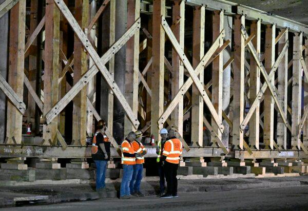 Construction workers gather at the repairs to the I-10 freeway, which was closed by an underpass fire on Saturday, Nov. 11, 2023, in Los Angeles on Nov. 19, 2023. (Alex Gallardo/AP)