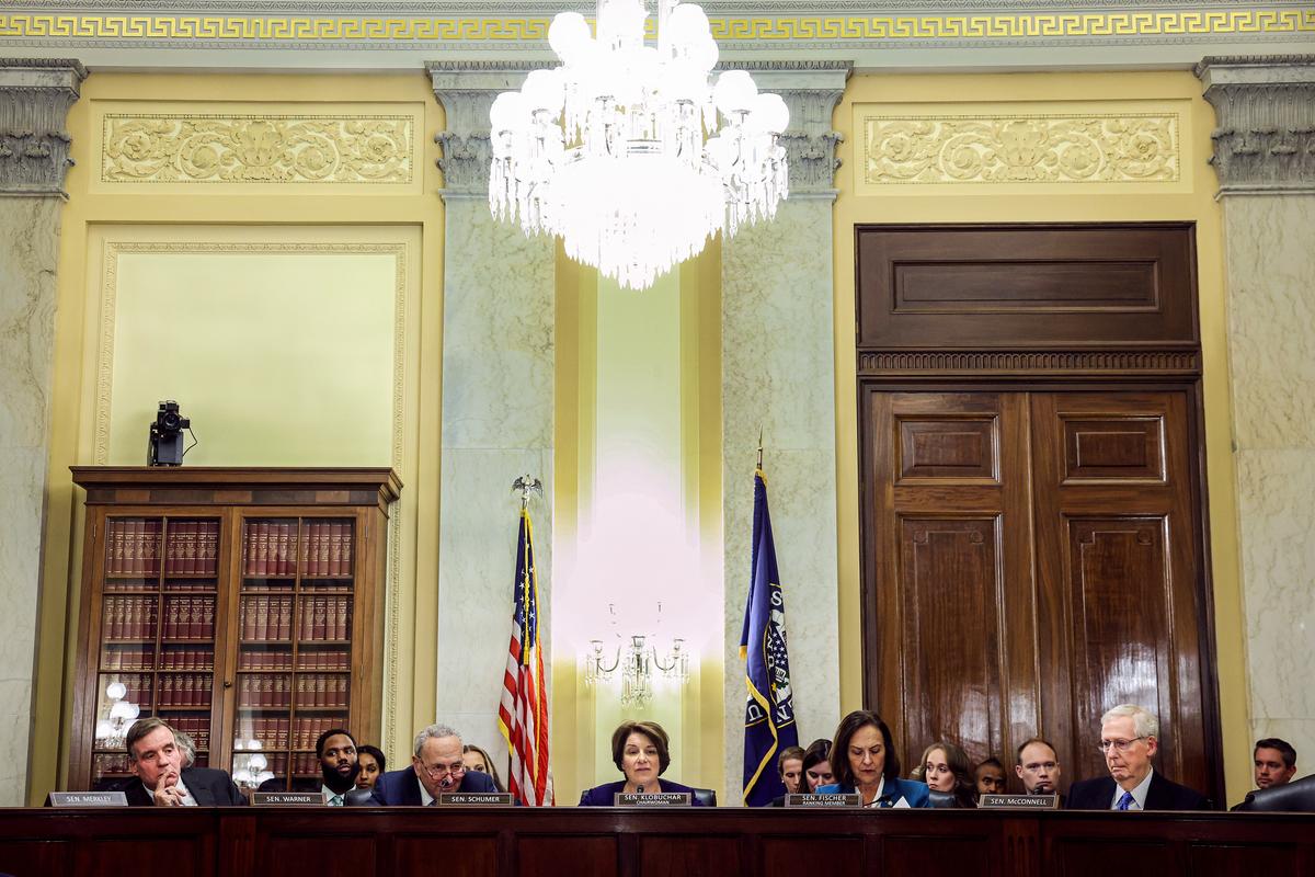 Sen. Mark Warner (D-Va.), Senate Majority Leader Charles Schumer (D-N.Y.), Senate Rules Committee Chair Amy Klobuchar (D-Minn.), Ranking Member Sen. Deb Fischer (R-Neb.) and Senate Minority Leader Mitch McConnell (R-Ky.) participate in a committee hearing in Washington on Nov. 14, 2023, in Washington. The committee voted to change the rules of the Senate to end Sen. Tommy Tuberville’s (R-Ala.) months-long holds on military nominees. (Kevin Dietsch/Getty Images)