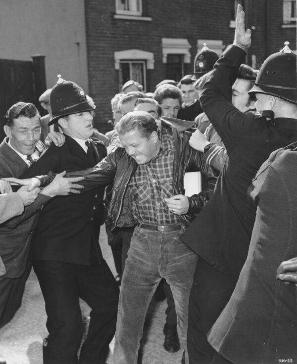Tom Curtis (Richard Attenborough) is accosted, in "The Angry Silence." (MovieStillsDB)