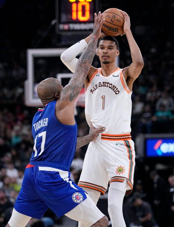 San Antonio Spurs center Victor Wembanyama (1) looks to pass over Los Angeles Clippers forward P.J. Tucker (17) during the first half of an NBA basketball game in San Antonio on Nov. 20, 2023. (Eric Gay/AP Photo)