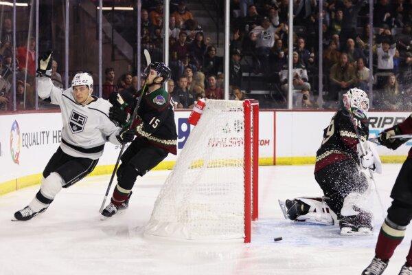 Trevor Moore (12) of the Los Angeles Kings celebrates after scoring a short-handed goal past Alexander Kerfoot (15) and goaltender Connor Ingram (39) of the Arizona Coyotes during the first period of the NHL game in Tempe, Ariz., on Nov. 20, 2023. (Christian Petersen/Getty Images)