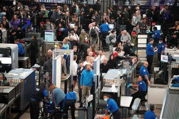 Travelers queue up to pass through the south security checkpoint at Denver International Airport, in Denver on Nov. 20, 2023. (David Zalubowski/AP)