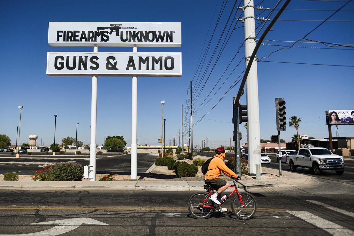 An AR-15 style rifle is displayed on signage for the Firearms Unknown Guns & Ammo store, in Yuma, Ariz., on June 2, 2022. (PATRICK T. FALLON/AFP via Getty Images)