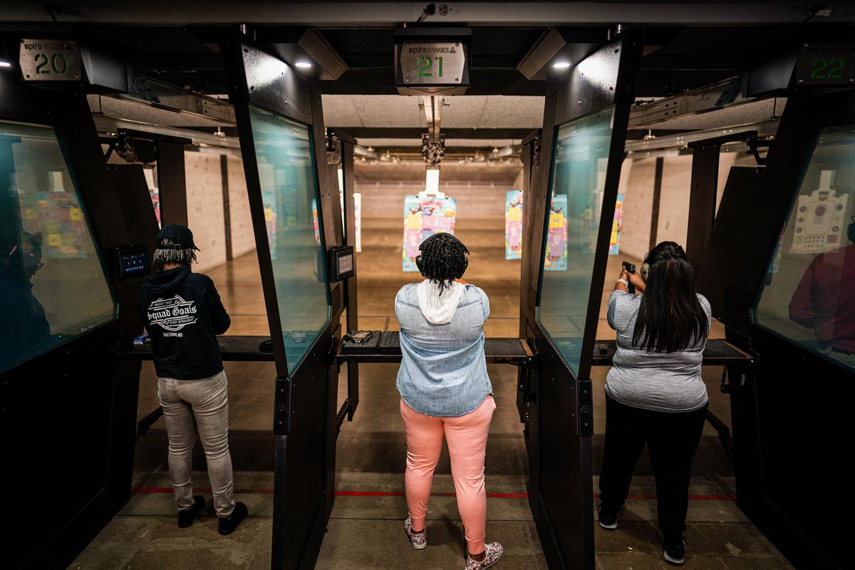 Marcia Threatt of Anne Arundal County, Chakiar Trotman of Tenleytown, and Adrian Williams of Baltimore all aim downrange during a shooting league at a firing range in Owings Mills, Md., on Sept., 27, 2023. (KENT NISHIMURA/AFP via Getty Images)
