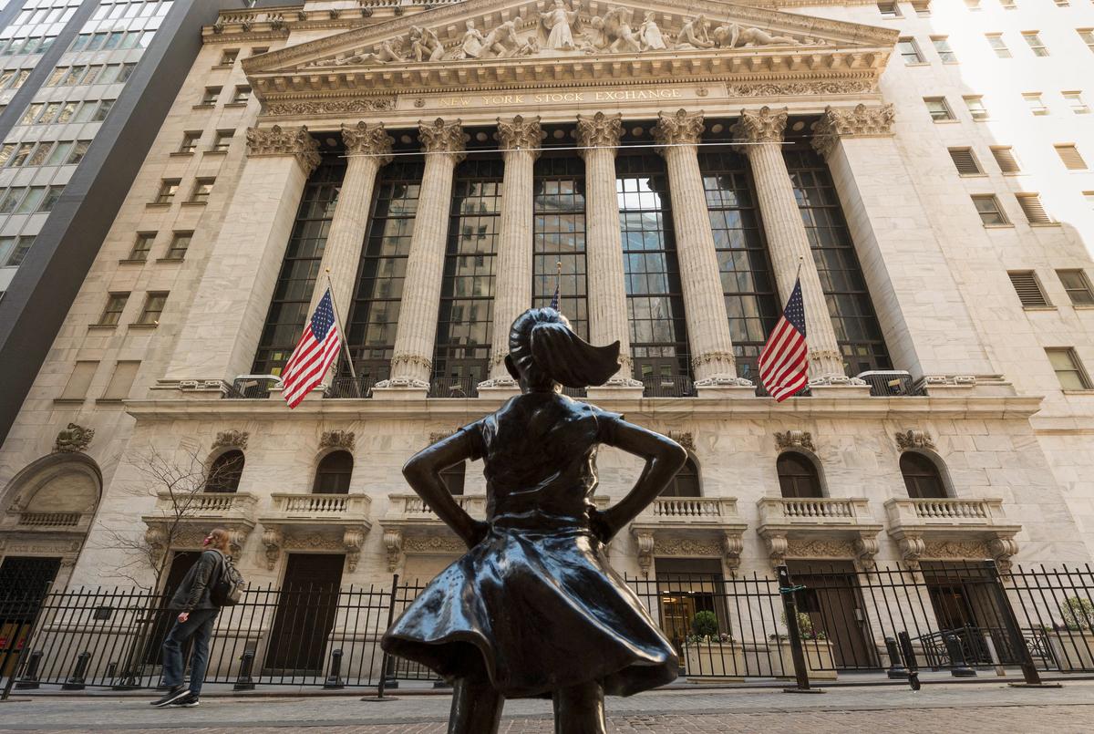 The New York Stock Exchange and the 'Fearless Girl' statue are seen on Wall Street in New York City on March 23, 2021. (ANGELA WEISS/AFP via Getty Images)