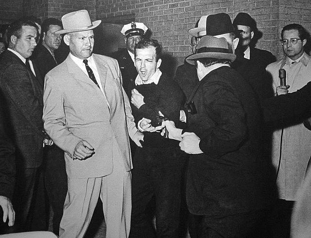 Jack Ruby shoots Lee Harvey Oswald, who was being escorted by police detective Jim Leavelle (tan suit) from the city jail to the county jail. Ruby died in prison in 1967. (Robert H. Jackson)