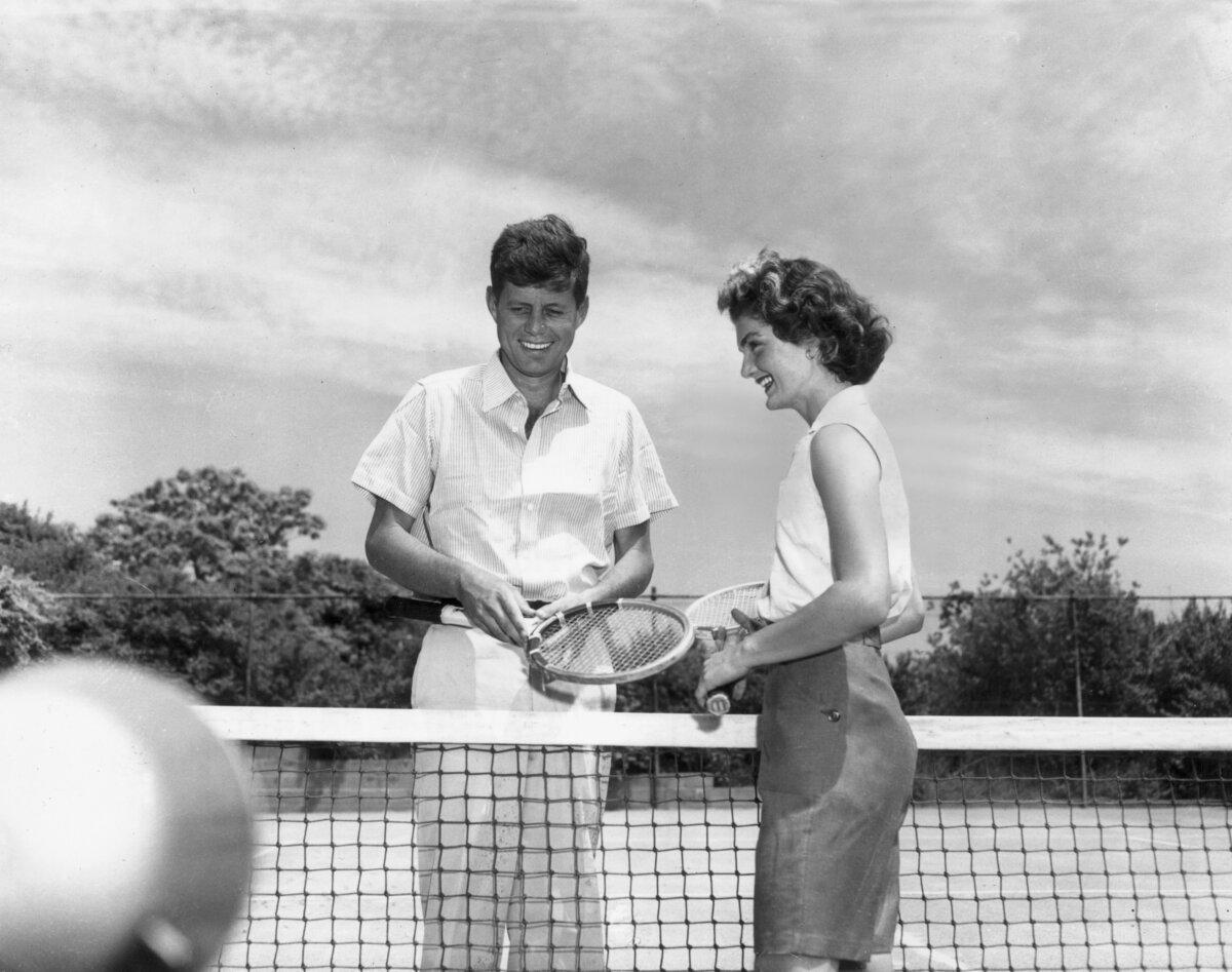 Sen. John F. Kennedy (D-Mass.) and his wife Jacqueline stand on either side of a tennis net, holding tennis racquets at Hyannis Port, Mass., on June 27, 1953. (Hulton Archive/Getty Images)