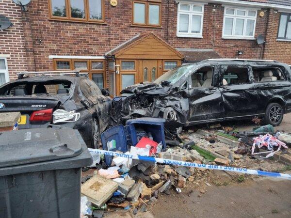 The wreckage left after Aidas Poskas crashed a stolen Range Rover into parked cars outside homes in west London on Sep. 26, 2023. (The Epoch Times)