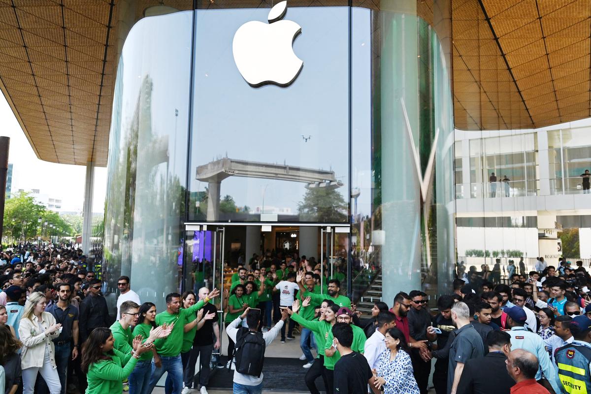 Apple employees (in green) cheer as they welcome customers during the opening of Apple's first retail store in Mumbai, India, on April 18, 2023. Apple has incresed its focus on the South Asian nation as a key sales market and alternative manufacturing hub to China. (PUNIT PARANJPE/AFP via Getty Images)