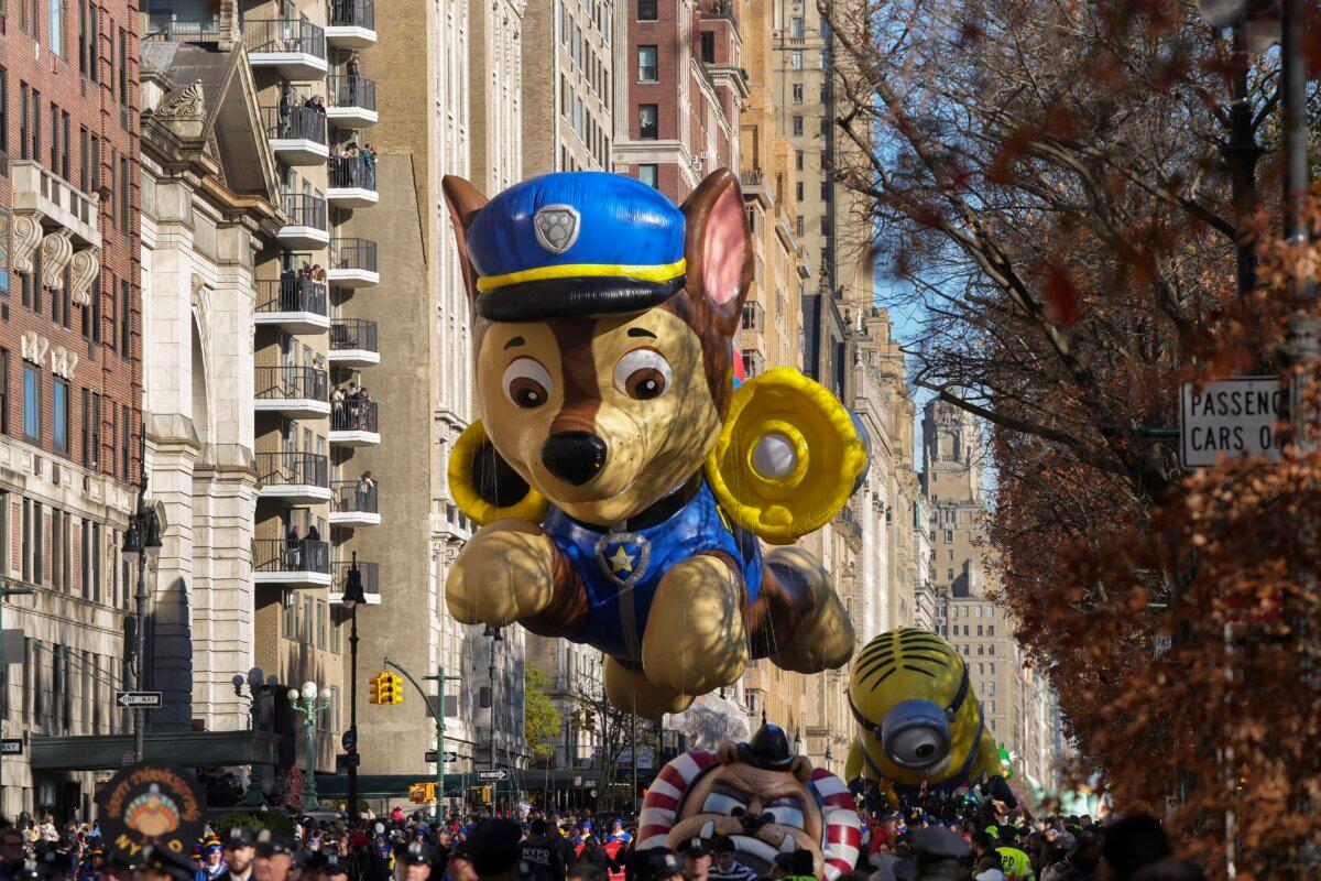 The handlers guide the Paw Patrol balloon along Central Park West during the Macy's Thanksgiving Day parade in New York on Nov. 23, 2023. (Jeenah Moon/AP Photo)