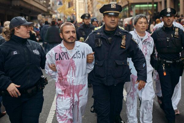 Demonstrators from a leftist group protesting the Israel–Hamas war get arrested by the police during the Macy's Thanksgiving Day Parade in New York, on Nov. 23, 2023. (Andres Kudacki/AP Photo)