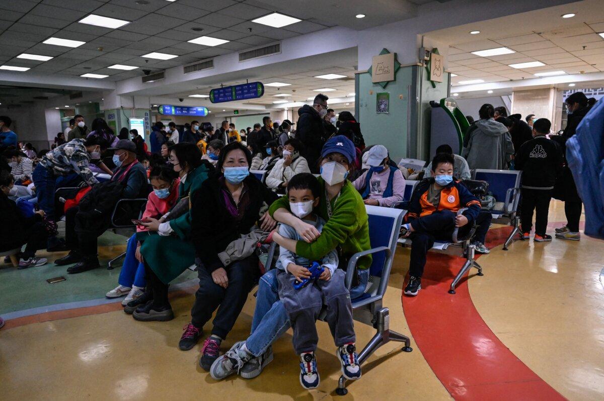 Children and their parents wait at an outpatient area at a children hospital in Beijing on Nov. 23, 2023. (Jade Gao/AFP via Getty Images)