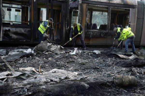 Debris is cleared from a burned out Luas tram the morning after a riot on O'Connell Street in Dublin, Ireland, on Nov. 24, 2023. (Brian Lawless/PA)
