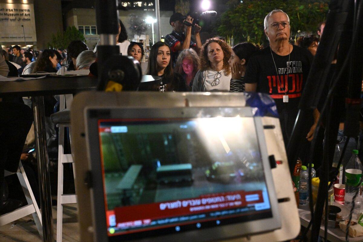 Families of the hostages and others watch the news broadcasts as hostages are released into Egypt before being brought into Israel by the ICRC, outside the Museum of Tel Aviv in Tel Aviv, Israel, on Nov. 24, 2023. (Alexi J. Rosenfeld/Getty Images)