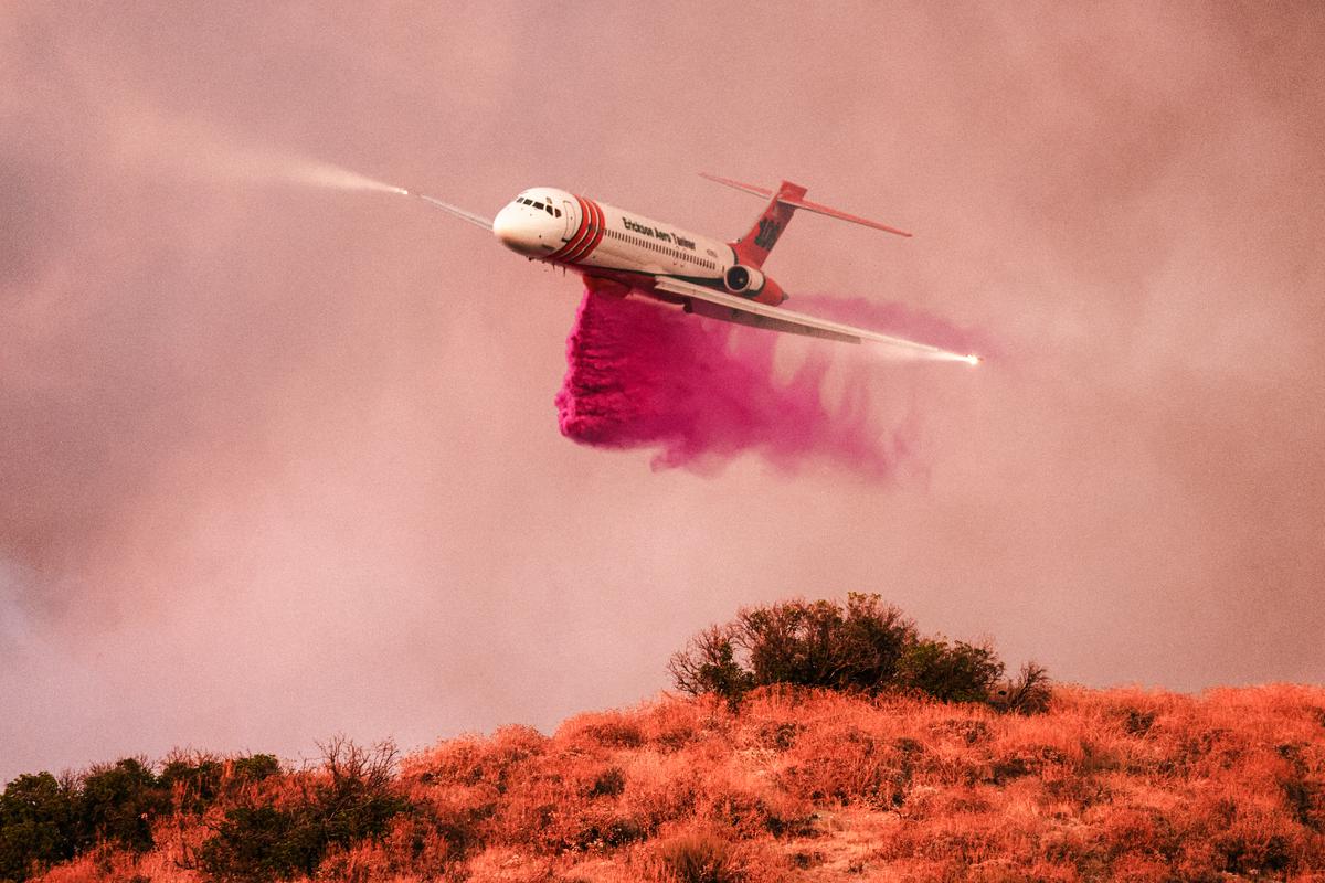 An aircraft drops fire retardant in Riverside County, Calif., on July 14, 2023. (David Swanson/AFP via Getty Images)