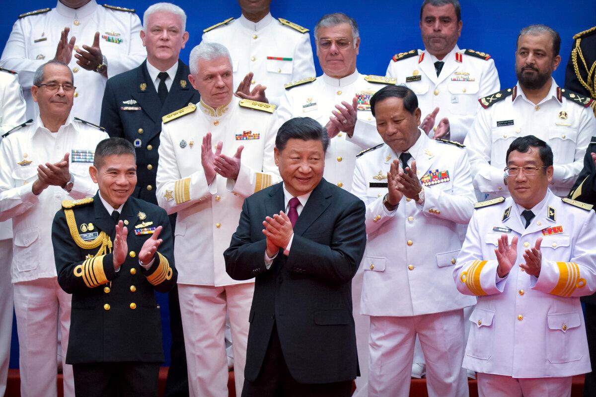 Chinese leader Xi Jinping (front-C) and Chinese and foreign naval officials applaud after a group photo during an event to commemorate the 70th anniversary of the Chinese People's Liberation Army (PLA) Navy in Qingdao, in eastern China's Shandong Province, on April 23, 2019. (Mark Schiefelbein/AFP via Getty Images)