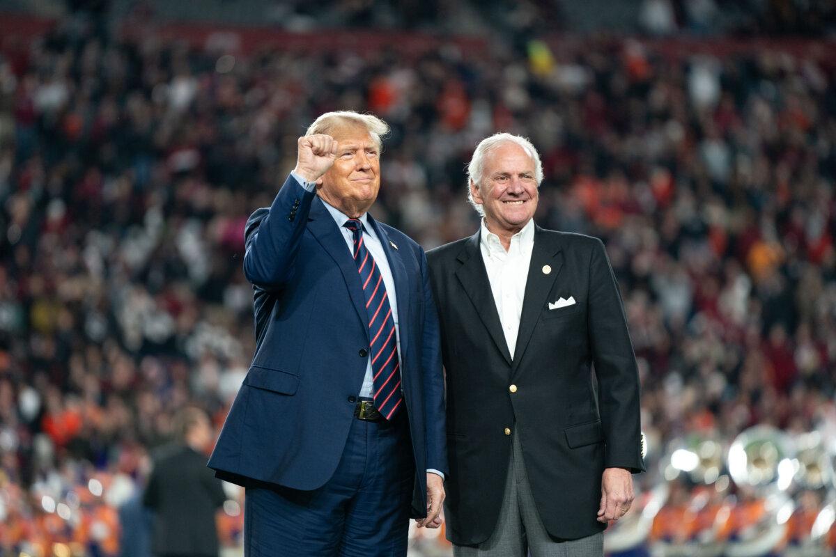 (L-R) Former President Donald Trump joins South Carolina Gov. Henry McMaster on the field during halftime in the Palmetto Bowl between Clemson and South Carolina at Williams Brice Stadium in Columbia, South Carolina, on Nov. 25, 2023. (Sean Rayford/Getty Images)