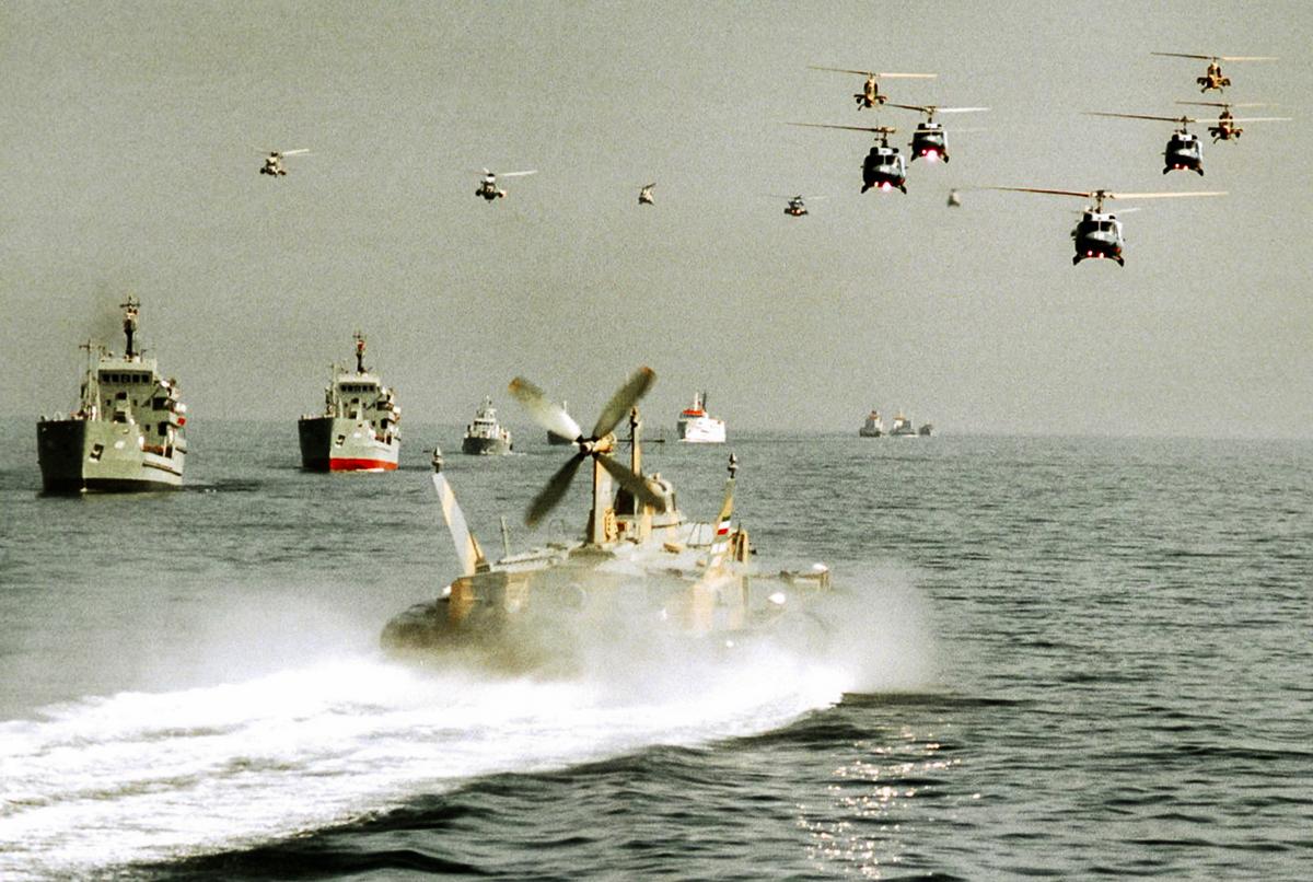 Iranian army helicopters and Navy boats take part in maneuvers during a war games exercise in the Strait of Hormuz and the Sea of Oman on Oct. 29, 2000. (AFP via Getty Images)