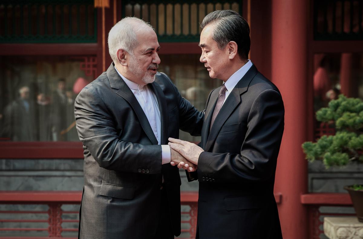 Iranian Foreign Minister Mohammad Javad Zarif (L), and his Chinese counterpart, Wang Yi, shake hands during their meeting in Beijing on Feb. 19, 2019. (HOW HWEE YOUNG/AFP via Getty Images)