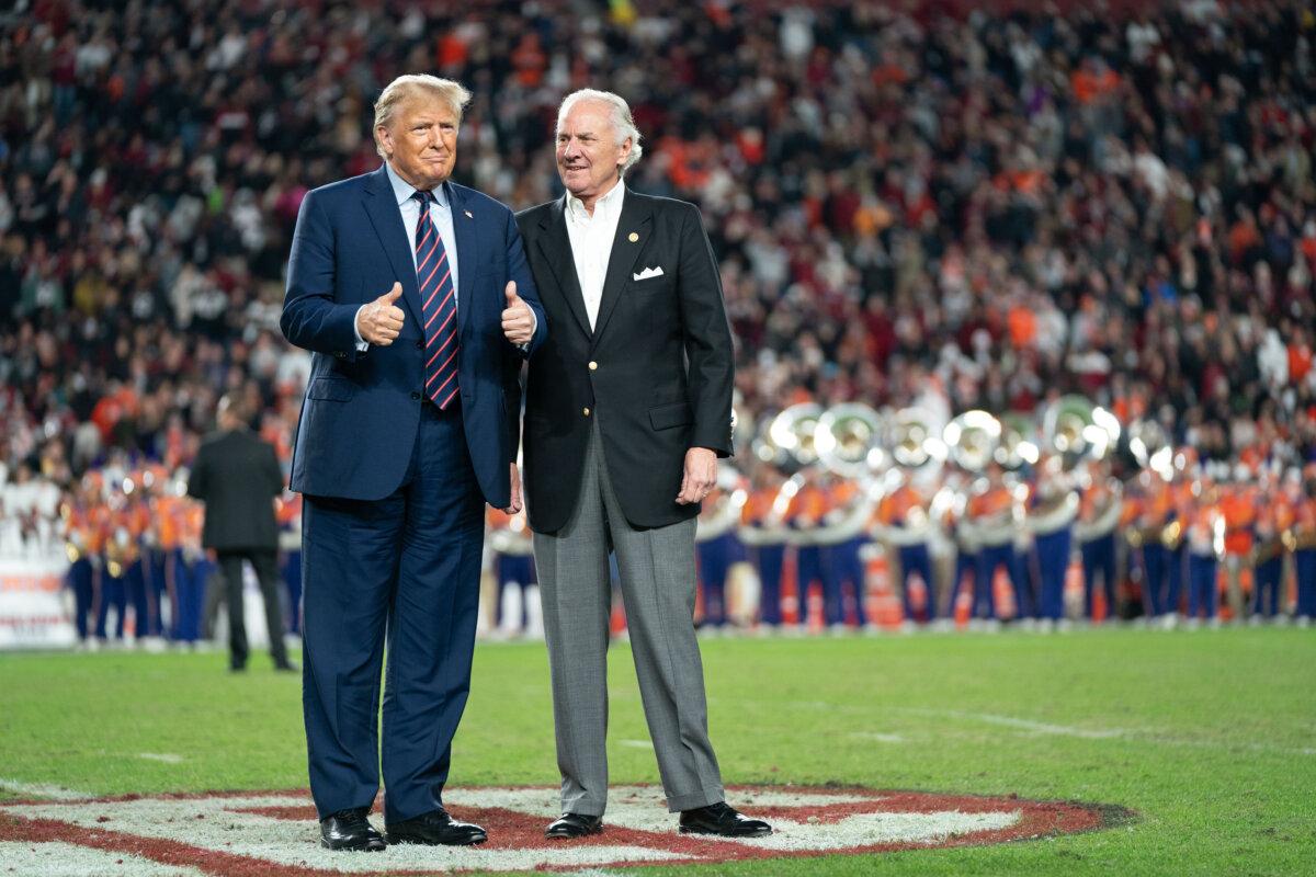 Former U.S. President Donald Trump joins South Carolina Gov. Henry McMaster on the field during halftime in the Palmetto Bowl between Clemson and South Carolina at Williams Brice Stadium in Columbia, S.C., on Nov. 25, 2023. (Sean Rayford/Getty Images)