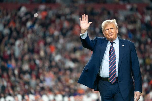 Former President Donald Trump waves to the crowd on the field during halftime in the Palmetto Bowl between Clemson and South Carolina at Williams Brice Stadium in Columbia, S.C., on Nov. 25, 2023. (Sean Rayford/Getty Images)