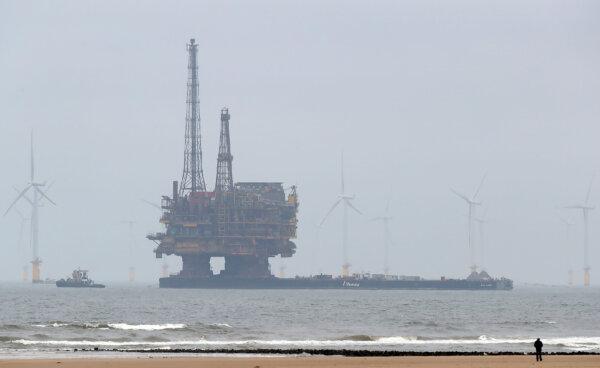 Shell's Brent Delta Topside offshore oil drilling rig platform is towed by tug boats along the coastline of Hartlepool in England, on May 2, 2017. (Scott Heppell/AFP via Getty Images)