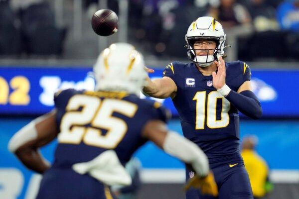 Los Angeles Chargers quarterback Justin Herbert (10) throws to running back Joshua Kelley (25) during the first half of an NFL football game in Inglewood, Calif., on Nov. 26, 2023. (Ashley Landis/AP Photo)