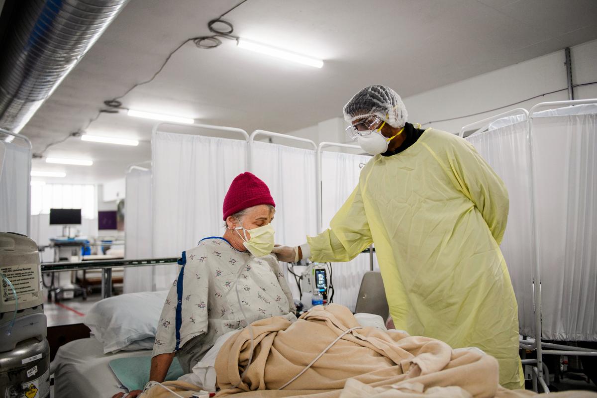 Dr. Bijay Sah attends to a patient in the COVID-19 alternative care site, built into a parking garage, at Renown Regional Medical Center in Reno, Nev., on Dec. 16, 2020. (PATRICK T. FALLON/AFP via Getty Images)