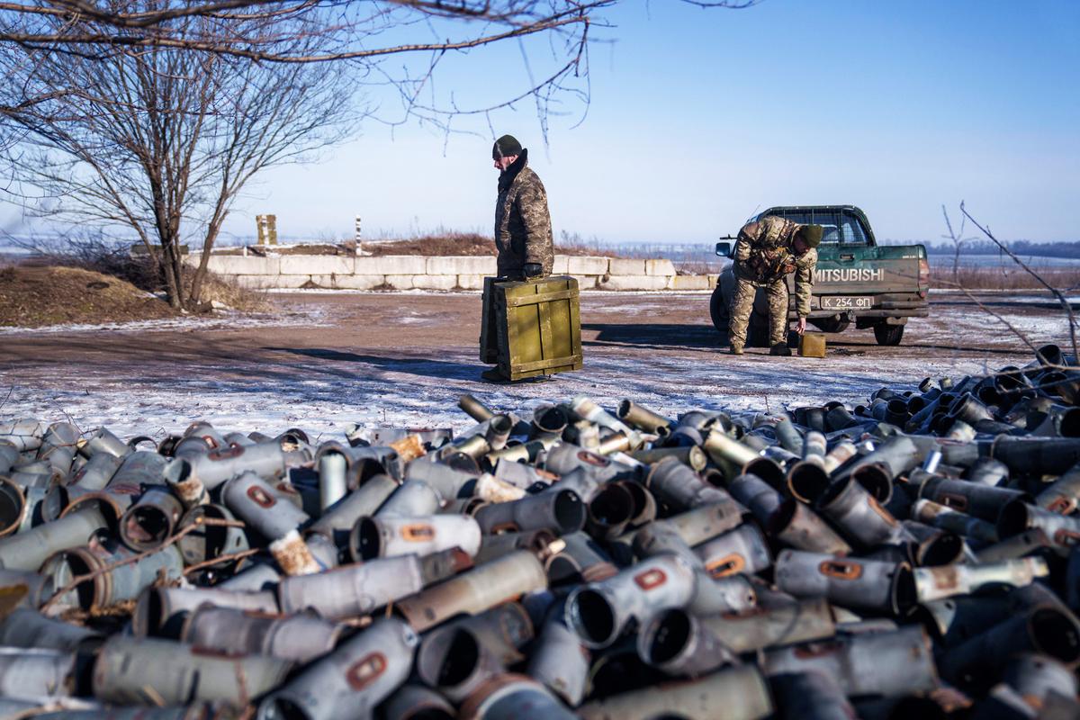  A helicopter crew member of the Ukrainian 18th Separate Army Aviation Brigade carries boxes of ammunition in eastern Ukraine on Feb. 9, 2023. (IHOR TKACHOV/AFP via Getty Images)