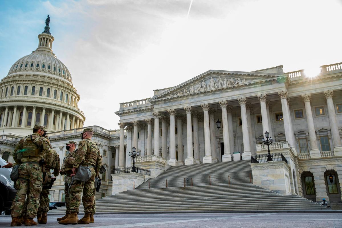 Military personnel gather outside the U.S. Capitol before President Joe Biden addresses a joint session of Congress in the House chamber of the U.S. Capitol in Washington on April 28, 2021. (Tasos Katopodis/Getty Images)