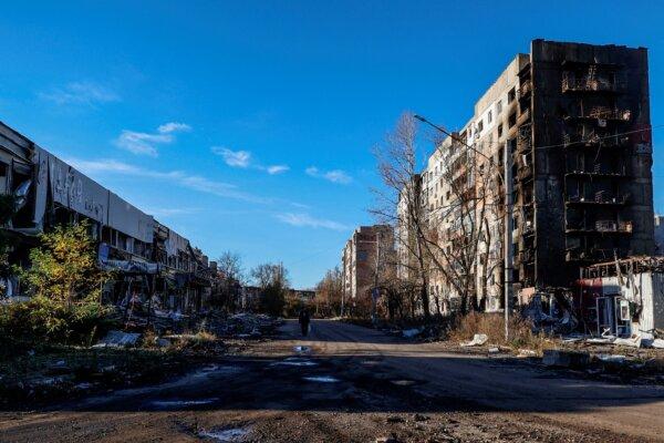 A resident walks past residential buildings damaged by Russian military strikes in the town of Avdiivka, on Nov. 8, 2023. (Radio Free Europe/Radio Liberty/Serhii Nuzhnenko via Reuters)