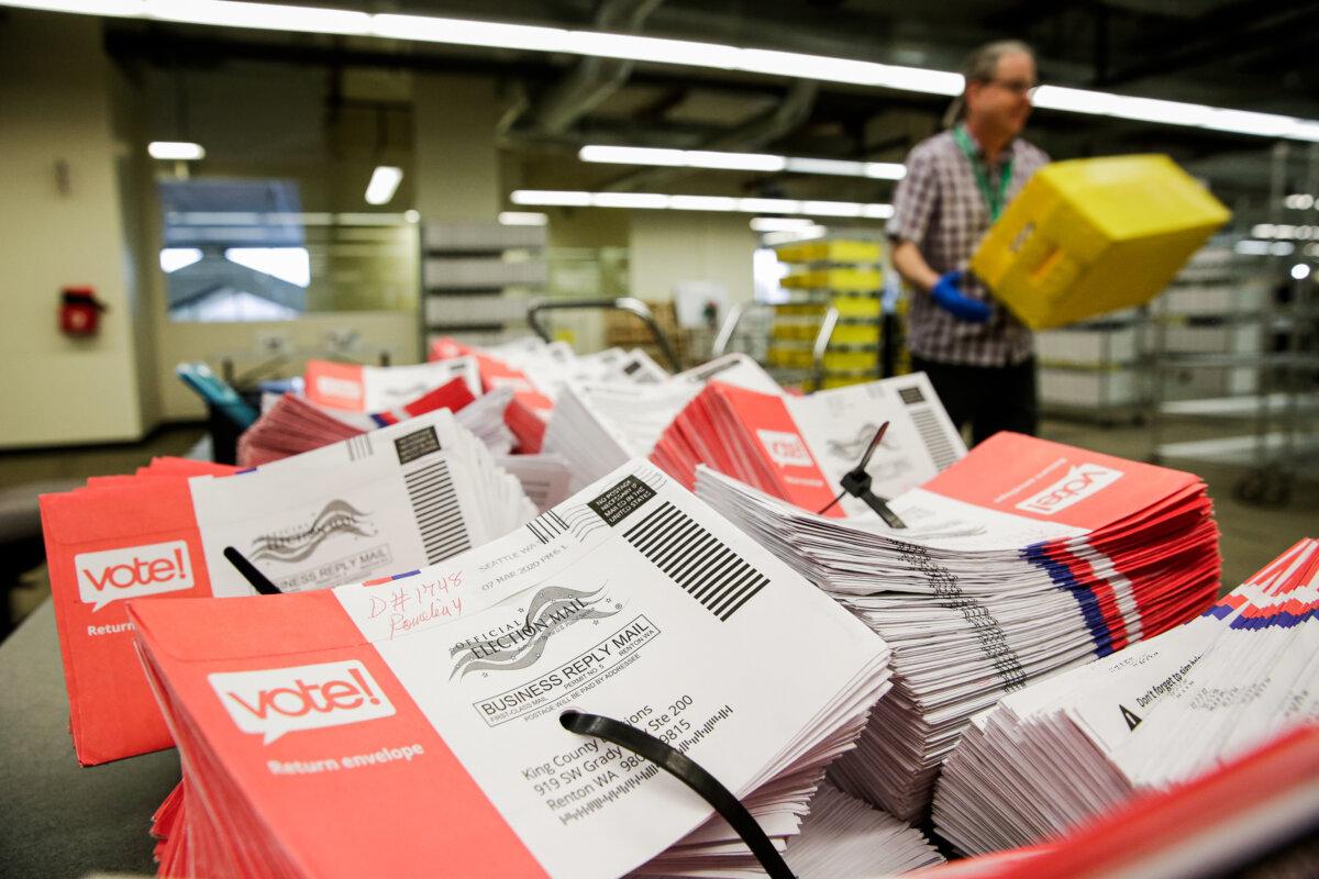 Empty envelopes of opened vote-by-mail ballots are stacked on a table at King County Elections in Renton, Washington, on March 10, 2020. (Jason Redmond/AFP via Getty Images)