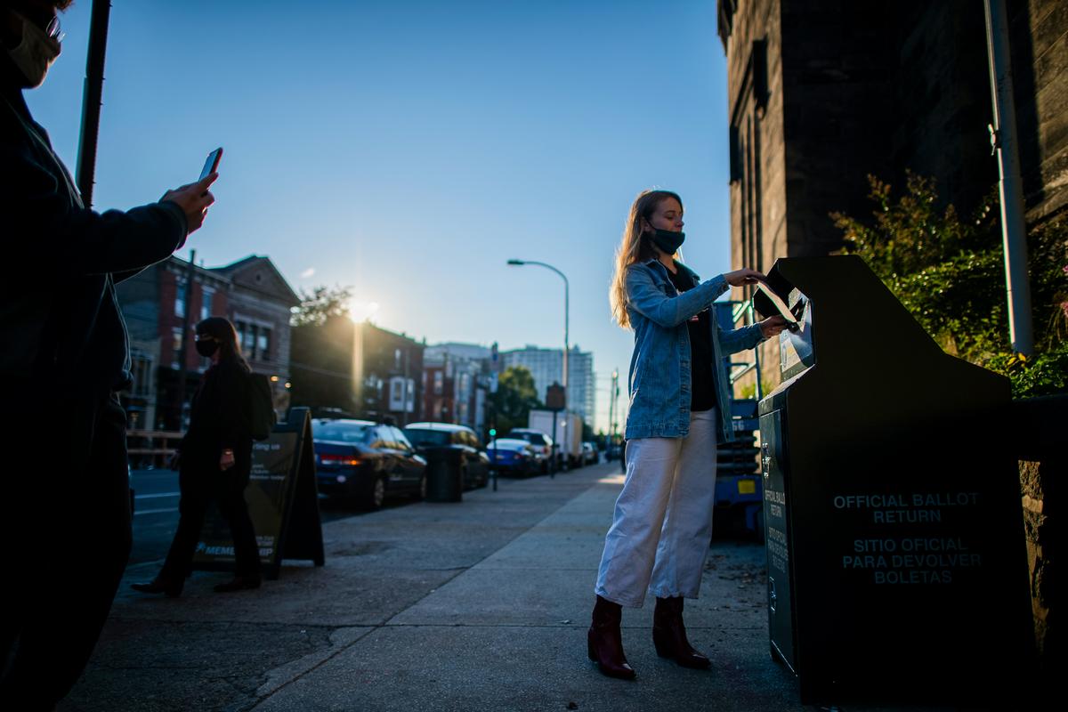 A woman drops her early voting ballot at drop box outside the Eastern State Penitentiary in Philadelphia on Oct. 17, 2020. Various state-level election rules changed in 2020, including allowing widespread mail-in voting, drop boxes, and processing of mail-in ballots before polls closed. (Mark Makela/Getty Images)