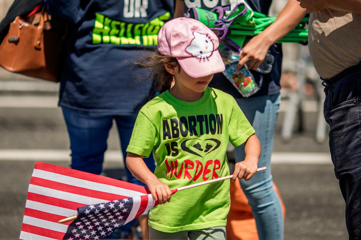  A child in evangelical Christian group wears a pro-life t-shirt and carries an American flag during the annual LA Pride Parade in West Hollywood, Calif,, on June 9, 2019. (DAVID MCNEW/AFP via Getty Images)