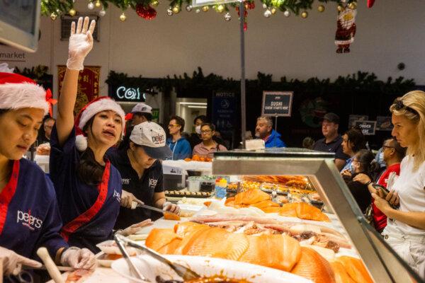Customers line up to order seafood at Sydney Fish Market in Sydney, Australia, on Dec. 24, 2022. (Jenny Evans/Getty Images)