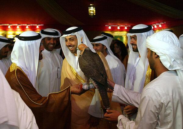 Sheikh Mansour Bin Zayed Al Nahyan smiles as he is shown a hunting falcon in Abu Dhabi Sept. 13, 2004. (Rabih Moghrabi/AFP)