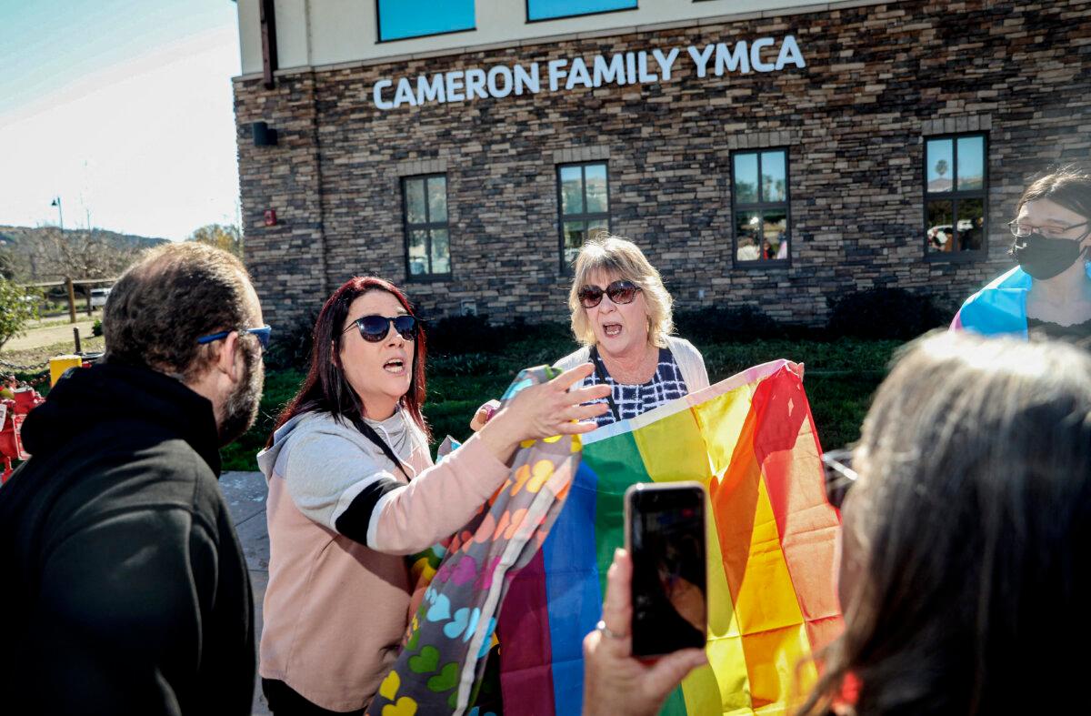 Pro-gender rights activist (C) faces off against protesters rallying against Christynne Wood, a biological male who identified as female and used the women’s locker room at the YMCA in Santee, a suburban city of San Diego County, Calif., on Jan. 21, 2023. (Sandy Huffaker /AFP via Getty Images)