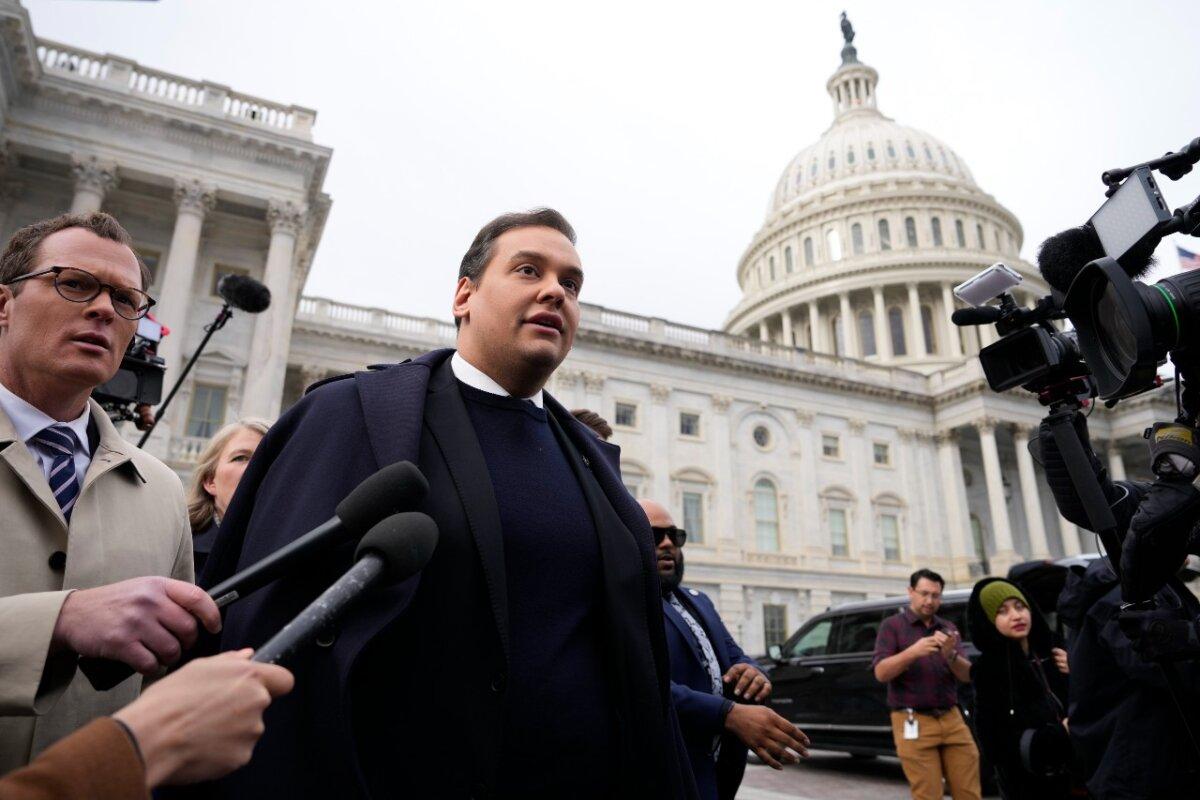 Rep. George Santos (R-N.Y.) is surrounded by journalists as he leaves the U.S. Capitol after his fellow members of Congress voted to expel him from the House of Representatives on Dec. 1, 2023, in Washington. (Drew Angerer/Getty Images)