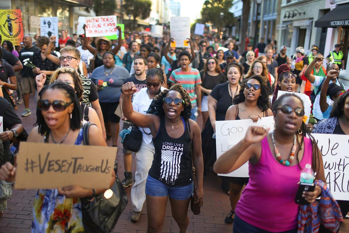  A march sponsored by the Black Lives Matter movement walks through the streets to commemorate the lives lost in the shooting at the Emanuel African Methodist Episcopal Church on June 20, 2015 in Charleston, South Carolina. Dylann Roof, 21 years old, has been charged with killing nine people during a prayer meeting in the church on June 17. (Photo by Joe Raedle/Getty Images)