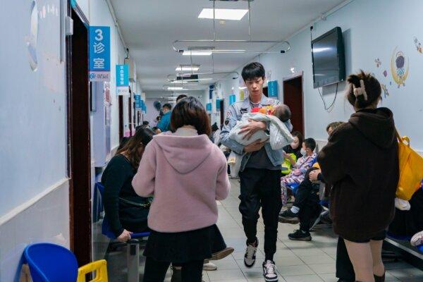Parents with children suffering from respiratory diseases line up at a children's hospital in Chongqing, China, on Nov. 23, 2023. (CFOTO/Future Publishing via Getty Images)