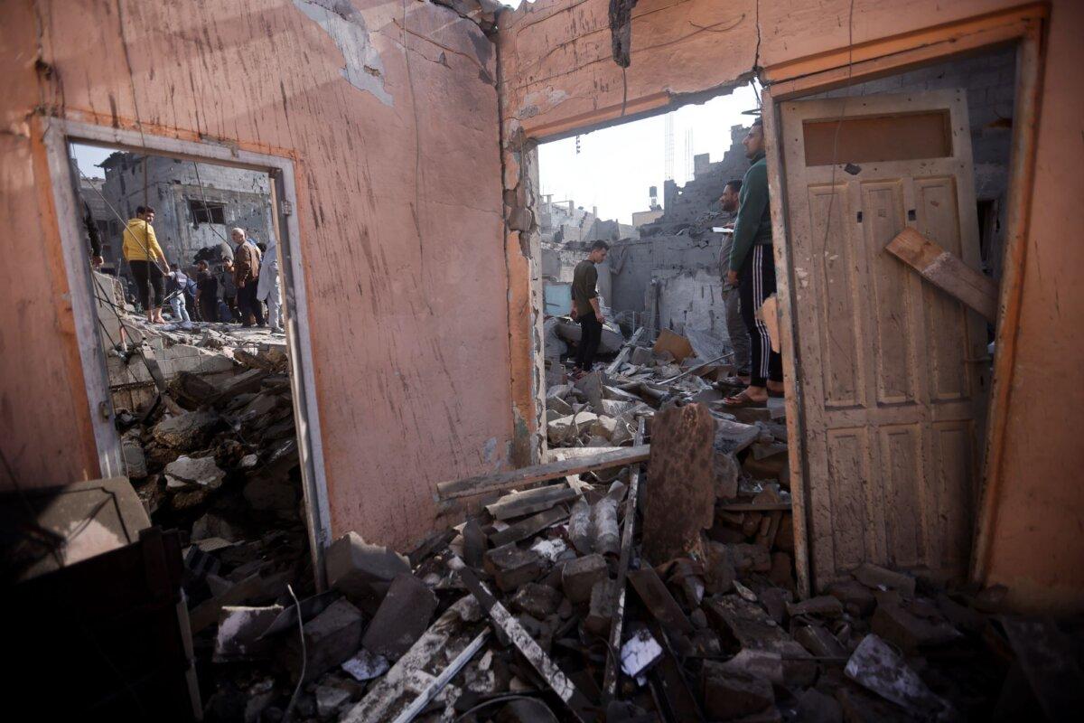 Palestinians look at destruction after the Israeli bombing In Khan Younis refugee camp in Gaza Strip on Dec. 1, 2023. (Mohammed Dahman/AP Photo)