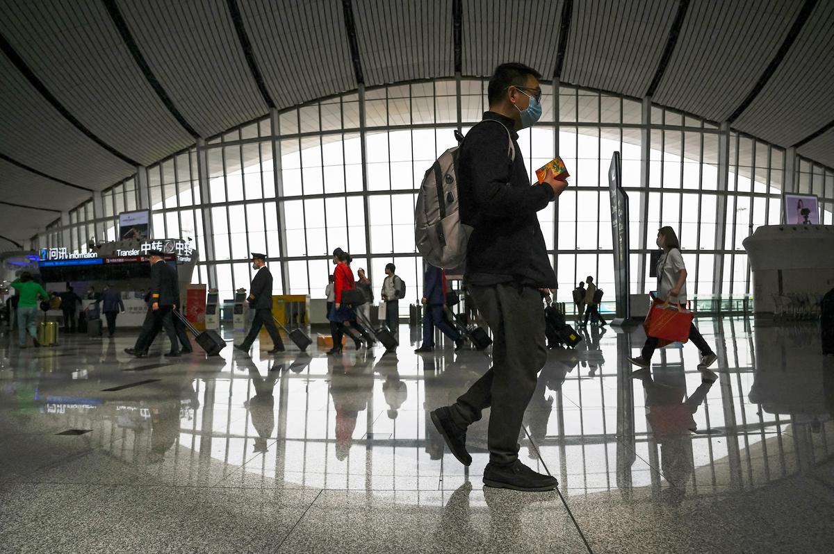 Passengers at the Beijing Daxing International Airport in China's capital city on April 28, 2023. (JADE GAO/AFP via Getty Images)