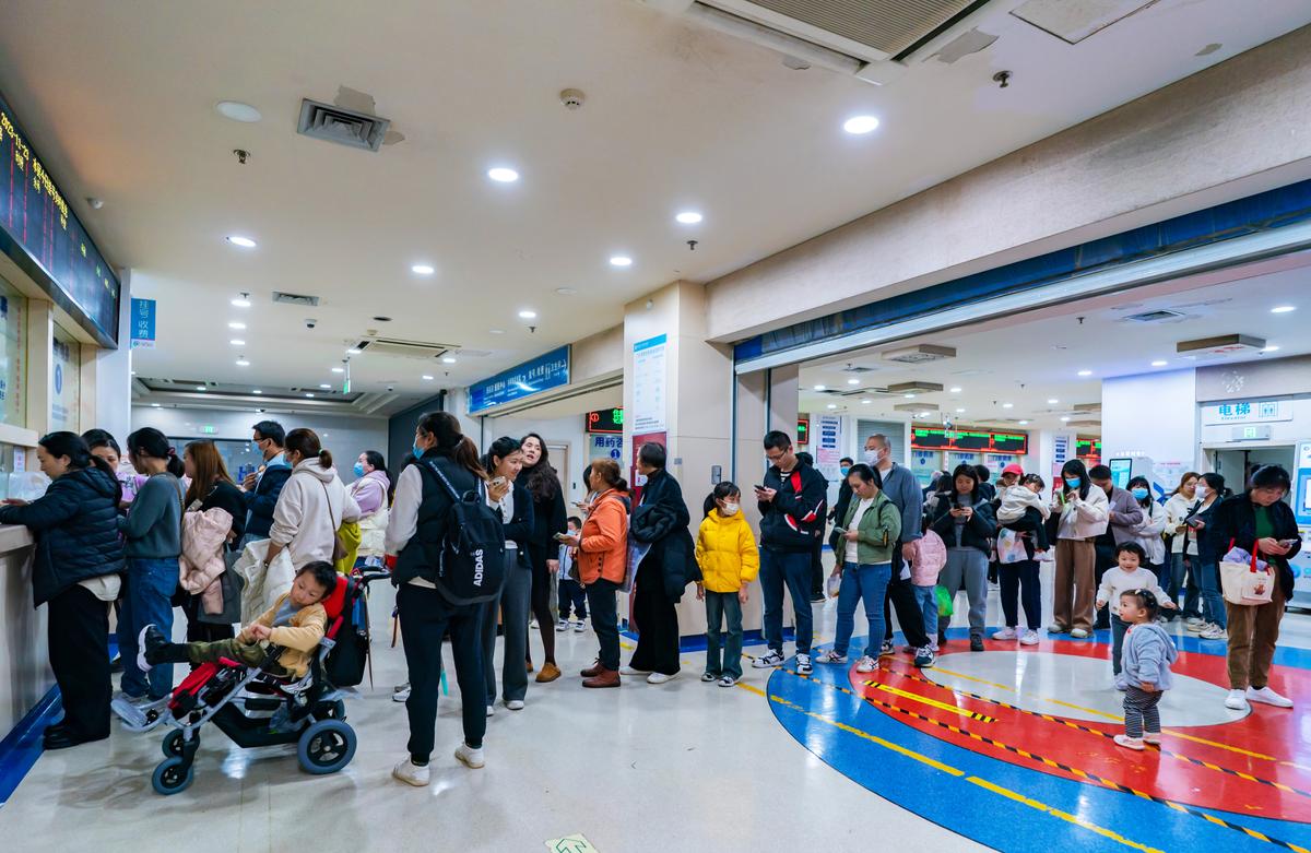 Parents with children suffering from respiratory illnesses line up at a children's hospital in Chongqing, China, on Nov. 23, 2023. (CFOTO/Future Publishing via Getty Images)