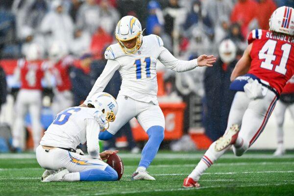 Cameron Dicker (11) of the Los Angeles Chargers kicks a field goal as JK Scott (16) holds in the second quarter against the New England Patriots in Foxborough, Mass., on Dec. 3, 2023. (Billie Weiss/Getty Images)
