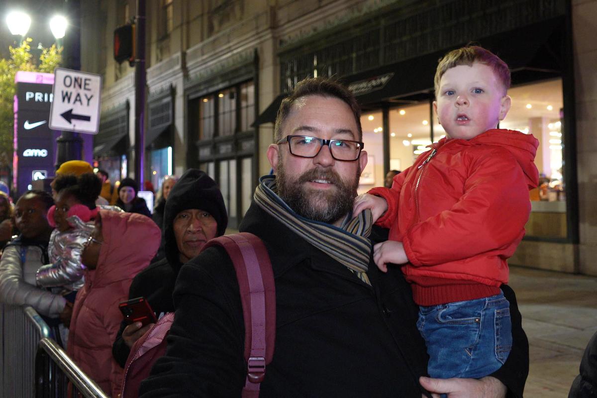 Michael Gall, a city planner in Philadelphia, tells The Epoch Times that he and his family thoroughly enjoy the parade during the Philadelphia Holiday Parade on Dec. 2, 2023. (Nancy Wang/The Epoch Times)
