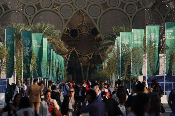 Participants walk under banners on day six of the UNFCCC COP28 Climate Conference at Expo City Dubai, in Dubai, United Arab Emirates, on Dec. 5, 2023. (Sean Gallup/Getty Images)