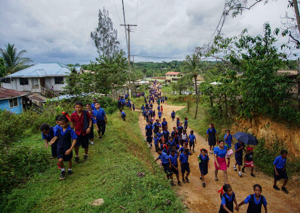 Children leave after school in Port Kaituma, Guyana, on Sept. 22, 2022. (PATRICK FORT/AFP via Getty Images)