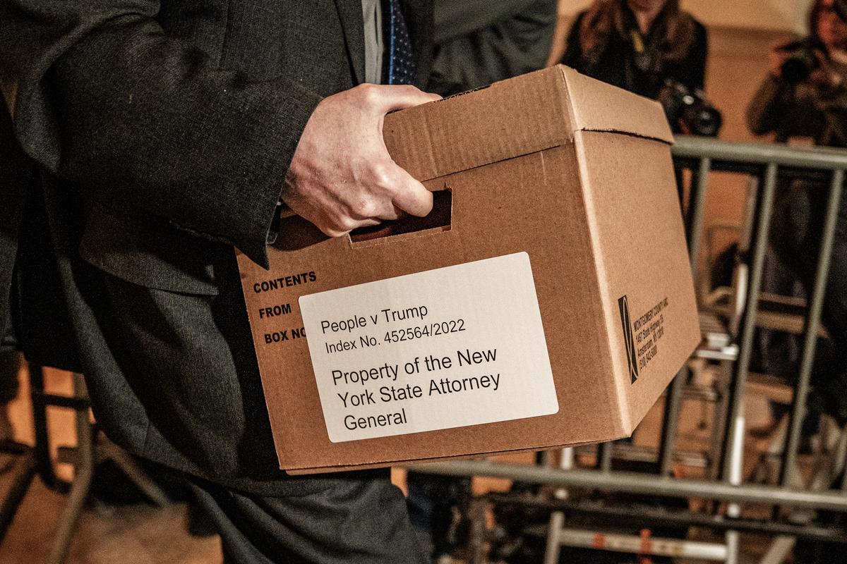 A New York state attorney general's office worker carries an evidence box as he arrives for The Trump Organization civil fraud trial in New York City on Nov. 1, 2023. (David Dee Delgado/Getty Images)