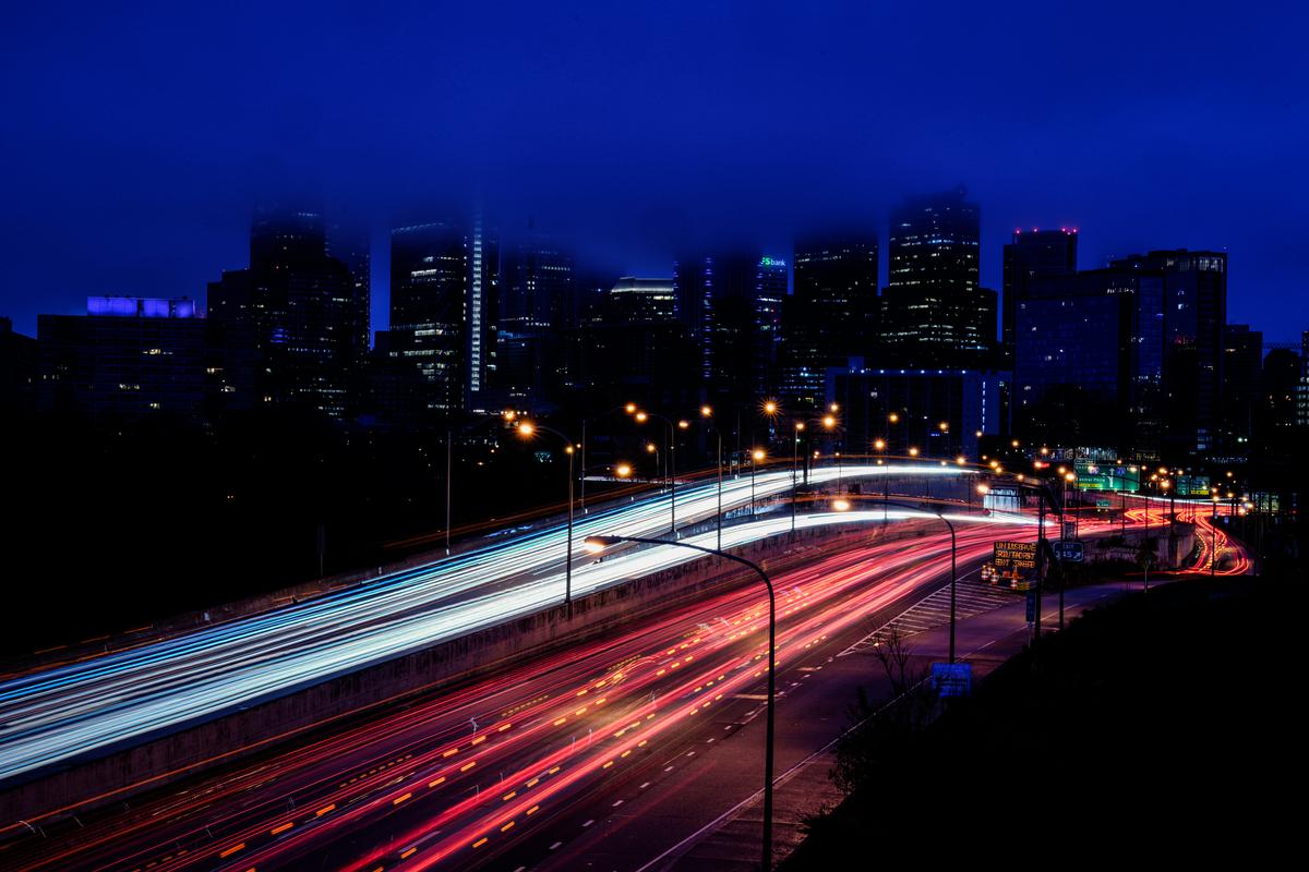 In this photo made with a long exposure, vehicles move along Interstate 76 ahead of the Thanksgiving Day holiday, in Philadelphia on Nov. 22, 2023. A big explanation for the recent decline in gas prices is seasonality, with prices at the pump almost always easing at this time of year. (AP Photo/Matt Rourke, File)