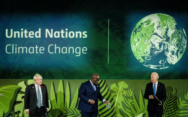 (L–R) British Prime Minister Boris Johnson, Congo President Felix Tshisekedi, and U.S. President Joe Biden on stage during the COP26 U.N. Climate Change Conference in Glasgow, Scotland, on Nov. 2, 2021. (Erin Schaff/POOL/AFP via Getty Images)
